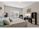 Calming main bedroom boasts neutral tones, a large window, and an entertainment center at 1000 Blackwolf Run Rd, Davenport, FL 33896