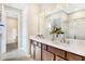 Elegant bathroom with double vanities, quartz countertops, and a glass-enclosed shower at 1003 Cloud Ridge Ct, Mount Dora, FL 32757