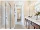This modern bathroom features a walk-in shower, dual sinks, and a view into the closet space at 1003 Cloud Ridge Ct, Mount Dora, FL 32757