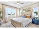 Inviting bedroom featuring a large window, neutral color scheme, and modern ceiling fan at 1003 Cloud Ridge Ct, Mount Dora, FL 32757