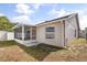 Exterior view of home, screened patio, and fenced yard at 1208 Roma Ct, Orlando, FL 32825