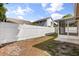 View of backyard with partial privacy fence and screened in porch at 1208 Roma Ct, Orlando, FL 32825
