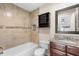 Bathroom with modern tiles and a dark wood vanity cabinet with light granite counter at 1208 Roma Ct, Orlando, FL 32825