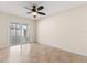 Bedroom features ceiling fan, sliding glass doors, and neutral decor at 1208 Roma Ct, Orlando, FL 32825
