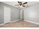 Bedroom featuring tile floors, ceiling fan, and closet at 1208 Roma Ct, Orlando, FL 32825