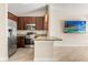 Modern kitchen featuring stainless steel appliances, granite countertops, and open layout to adjacent living spaces at 1208 Roma Ct, Orlando, FL 32825