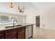 Modern kitchen featuring stainless steel appliances, granite countertops, and open layout to adjacent living spaces at 1208 Roma Ct, Orlando, FL 32825