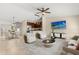 Cozy living room featuring a flat-screen TV, a dining area, and a modern kitchen with stainless steel appliances at 1208 Roma Ct, Orlando, FL 32825