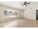 Bright and spacious living room with large windows offering ample natural light and stylish tiled floors at 1208 Roma Ct, Orlando, FL 32825