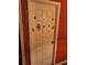 A white door with stickers on a red wall at 135 Pine Island Cir, Kissimmee, FL 34743