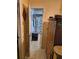 Hallway leading to bathroom showing tiled floor and wooden cabinet at 135 Pine Island Cir, Kissimmee, FL 34743