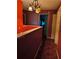 Hallway with a yellow light fixture and doorway to bedroom at 135 Pine Island Cir, Kissimmee, FL 34743