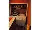 Laundry room with washer and dryer with red walls and open shelving at 135 Pine Island Cir, Kissimmee, FL 34743