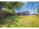 A spacious, grassy backyard with a fence, screened pool, and shed provides a private outdoor oasis at 1594 Frances St, Kissimmee, FL 34744