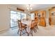 Bright dining room with screened-in porch access, chandelier lighting, and a classic wooden dining set at 1594 Frances St, Kissimmee, FL 34744