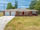 Charming single-story home featuring a brick facade, well-manicured lawn, and a two-car garage at 1594 Frances St, Kissimmee, FL 34744