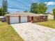 Attractive single-story house showcasing brick details, a spacious driveway, and an attached garage at 1594 Frances St, Kissimmee, FL 34744