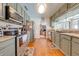 Charming kitchen featuring updated cabinets, countertops, and stainless steel appliances and hardwood floors at 1594 Frances St, Kissimmee, FL 34744