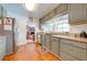 Cozy kitchen with ample counter space, stainless steel appliances, hardwood floors, and convenient access to the living area at 1594 Frances St, Kissimmee, FL 34744