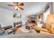 Cozy living room with a brick fireplace, hardwood floors, ceiling fan, and comfortable seating arrangement at 1594 Frances St, Kissimmee, FL 34744