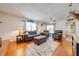 Inviting living room featuring hardwood floors, brick fireplace, comfortable seating, and natural light at 1594 Frances St, Kissimmee, FL 34744