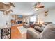 Bright living room featuring a brick fireplace, hardwood floors, ceiling fan, and comfortable seating arrangement at 1594 Frances St, Kissimmee, FL 34744
