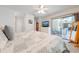 Bright main bedroom featuring access to a patio with ceiling fan and a television on top of a dresser at 1594 Frances St, Kissimmee, FL 34744