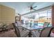 View of the outdoor patio with outdoor dining and view of the pool under the screened enclosure at 1594 Frances St, Kissimmee, FL 34744