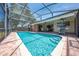 A beautiful screened-in pool with brick pavers and landscaping offers a relaxing outdoor space at 1594 Frances St, Kissimmee, FL 34744