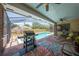 Outdoor dining area with a grill and covered pool with screened enclosure in backyard at 1594 Frances St, Kissimmee, FL 34744