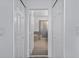 Hallway view to the modern bathroom with a soaking tub and a glass-enclosed walk-in shower at 1809 Portofino Meadows Blvd, Orlando, FL 32824