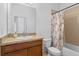 Bathroom with a granite vanity, ceramic sink, and a shower/tub combo with themed shower curtain at 1809 Portofino Meadows Blvd, Orlando, FL 32824