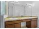 Bright bathroom featuring double sinks, granite countertops, and large mirror at 1809 Portofino Meadows Blvd, Orlando, FL 32824