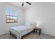 Bright bedroom featuring a window view and a modern ceiling fan for a fresh, airy atmosphere at 1809 Portofino Meadows Blvd, Orlando, FL 32824