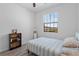 Cozy bedroom with a ceiling fan, large window, and light gray wood-look floors at 1809 Portofino Meadows Blvd, Orlando, FL 32824