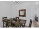 Cozy dining area with dark wood table, seating for four, and a decorative mirror at 1809 Portofino Meadows Blvd, Orlando, FL 32824