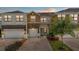Inviting townhome with brick driveway, two-car garage, and well-maintained landscaping at 1809 Portofino Meadows Blvd, Orlando, FL 32824