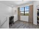 Home office area featuring a work desk, chair, and a large window overlooking the neighborhood at 1809 Portofino Meadows Blvd, Orlando, FL 32824