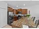 Modern kitchen featuring stainless steel appliances, granite countertops, and ample cabinet space at 1809 Portofino Meadows Blvd, Orlando, FL 32824