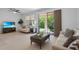 Comfortable living room with a sliding glass door leading to an outdoor patio and backyard views at 1809 Portofino Meadows Blvd, Orlando, FL 32824