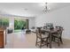 Open-concept living area with tile flooring, dining area, and a sliding glass door to the backyard at 1809 Portofino Meadows Blvd, Orlando, FL 32824