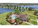Aerial view of community pool, clubhouse and lush landscaping near a picturesque pond at 1809 Portofino Meadows Blvd, Orlando, FL 32824