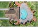 Top-down shot of the kidney-shaped community pool and sundeck shaded by a covered pavilion at 1809 Portofino Meadows Blvd, Orlando, FL 32824