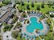 Aerial view showcasing the large pool area with seating, landscaping, and nearby community amenities at 1817 Caribbean View Ter, Kissimmee, FL 34747
