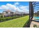 Expansive backyard with a black metal fence provides privacy and security around the outdoor pool at 1817 Caribbean View Ter, Kissimmee, FL 34747