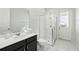 Bright bathroom featuring a glass shower, white cabinets, and a large mirror at 1817 Caribbean View Ter, Kissimmee, FL 34747
