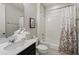 Neat bathroom featuring white sink and cabinet, decorative towels and bath with shower curtain at 1817 Caribbean View Ter, Kissimmee, FL 34747