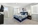 Inviting bedroom featuring a plush blue bed, bright windows, and stylish decor for a comfortable retreat at 1817 Caribbean View Ter, Kissimmee, FL 34747