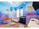 Charming Bedroom with ocean-themed wall art and a white crib at 1817 Caribbean View Ter, Kissimmee, FL 34747