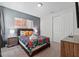 Cozy bedroom featuring a queen bed with a colorful comforter, stylish nightstands, and modern decor at 1817 Caribbean View Ter, Kissimmee, FL 34747
